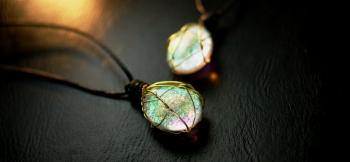 ラフォルム ガラスジュエリー ガラスアクセサリー Memories of grain ～ Braided drop ～ 表裏に膨らみのあるフォルムに仕上げたドロップタイプのルースを、金色に輝く真鍮コードを二種類使用し包み込むように編みこんだワイヤー…