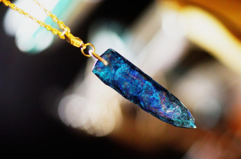 星空を宿すArrowhead 深い青と輝く光が交錯する、矢じり型ペンダントのショット。ランダムに施されたアイスロックカットが、光の反射を美しく演出し、アクアマリンブルーの神秘的な色合いが際立ちます。… ラフォルム ガラスジュエリー ガラスアクセサリー
